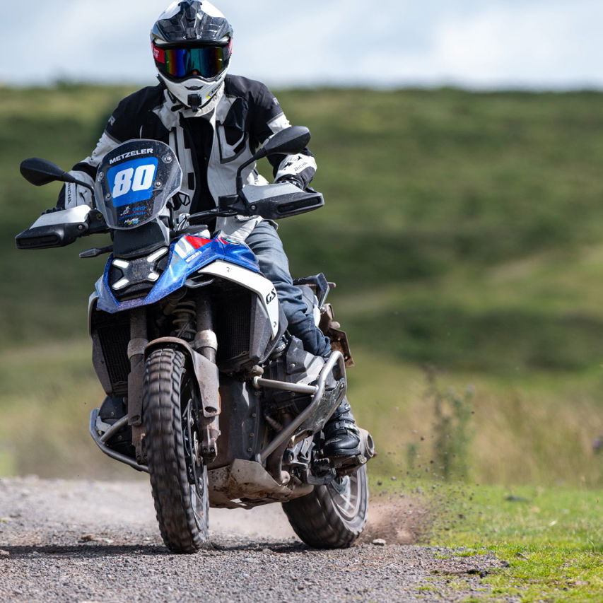 A BMW R1300 GS sliding on gravel